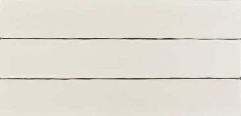 a close up of a white tile wall